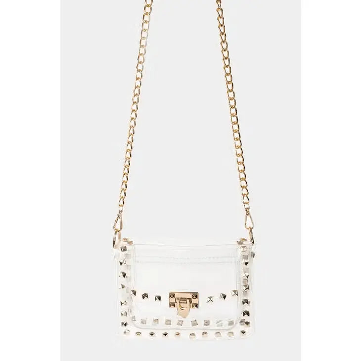 Clear studded crossbody bag with gold chain strap and twist-lock closure.